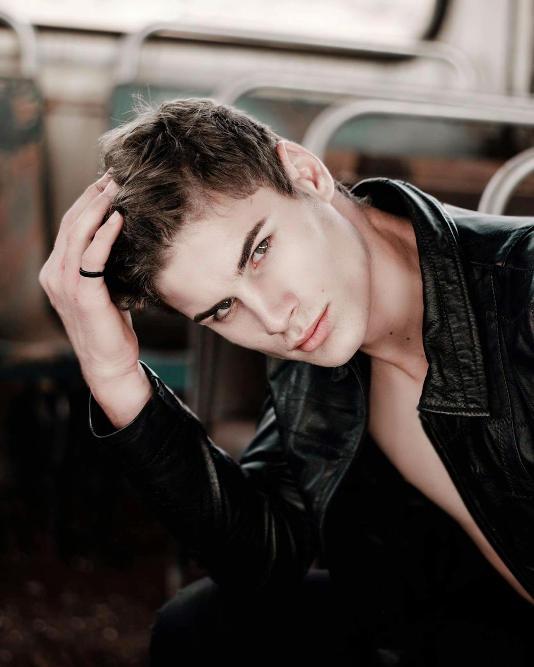 selective focus photography of man touching his hair