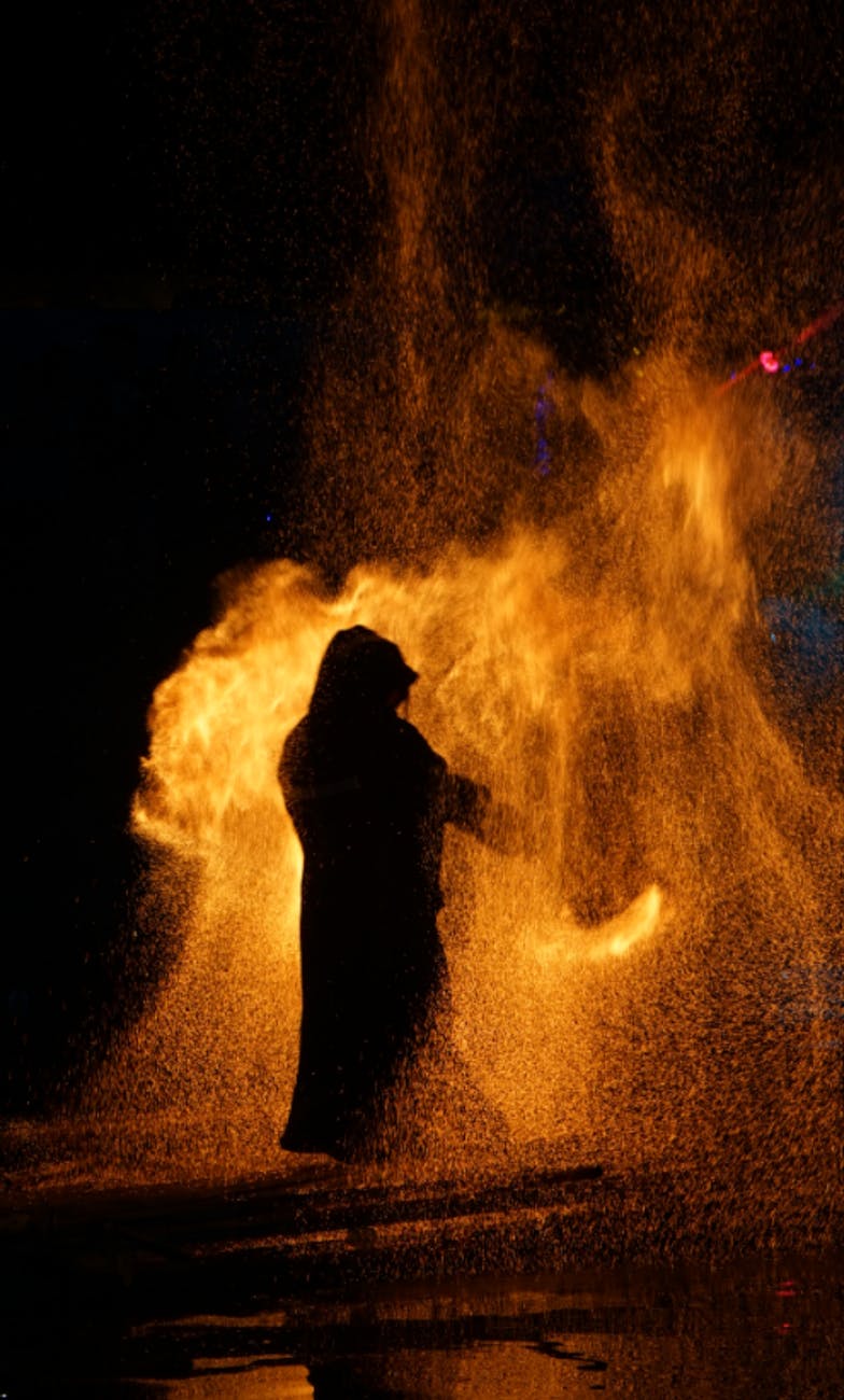 dramatic fire dance silhouette at night